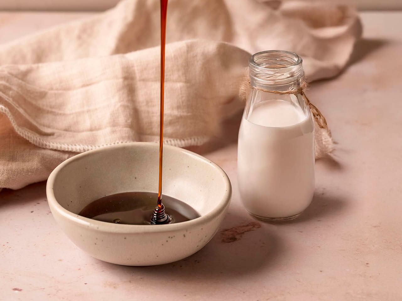 Une bouteille de lait et un plat avec du caramel dedans